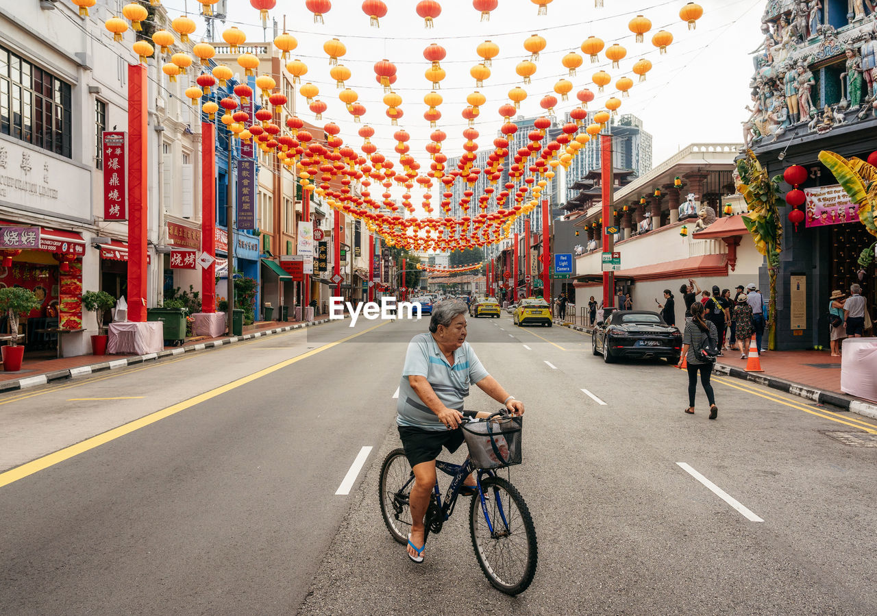 PEOPLE RIDING BICYCLE ON ROAD