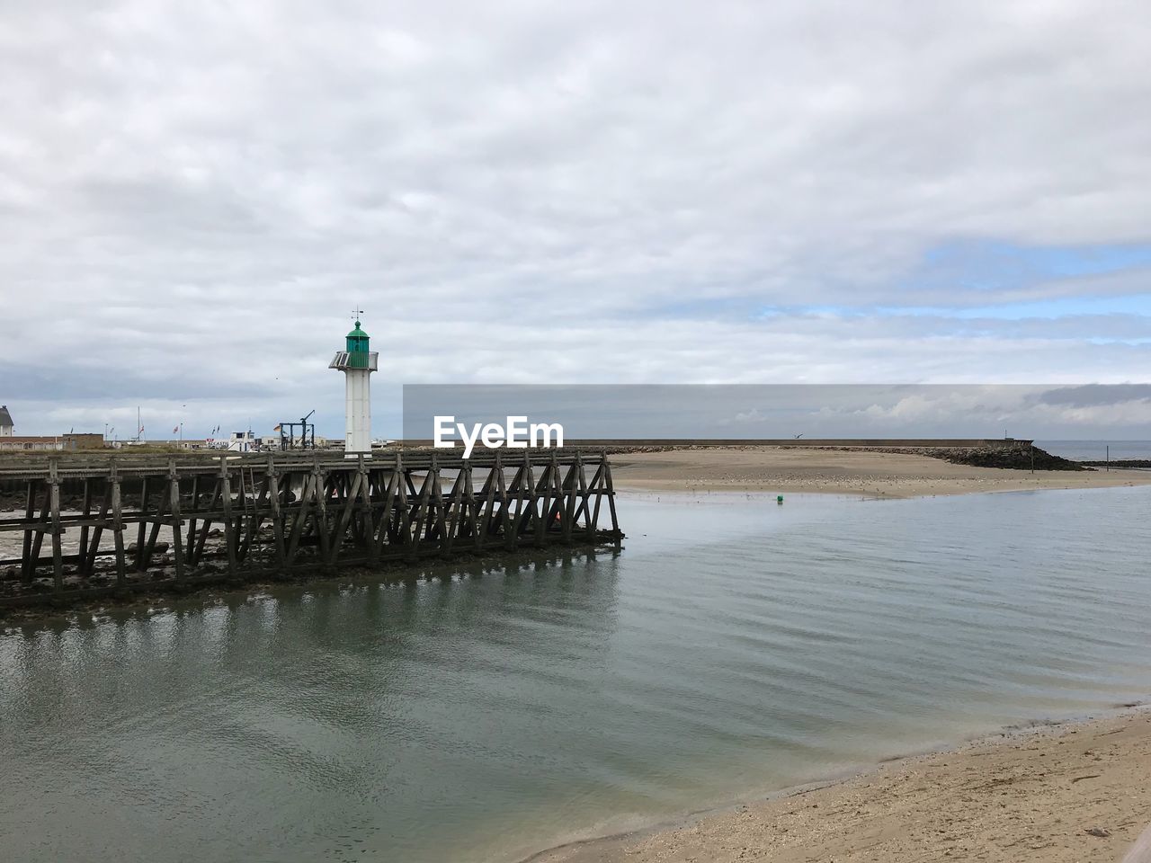 LIGHTHOUSE ON BEACH AGAINST SKY