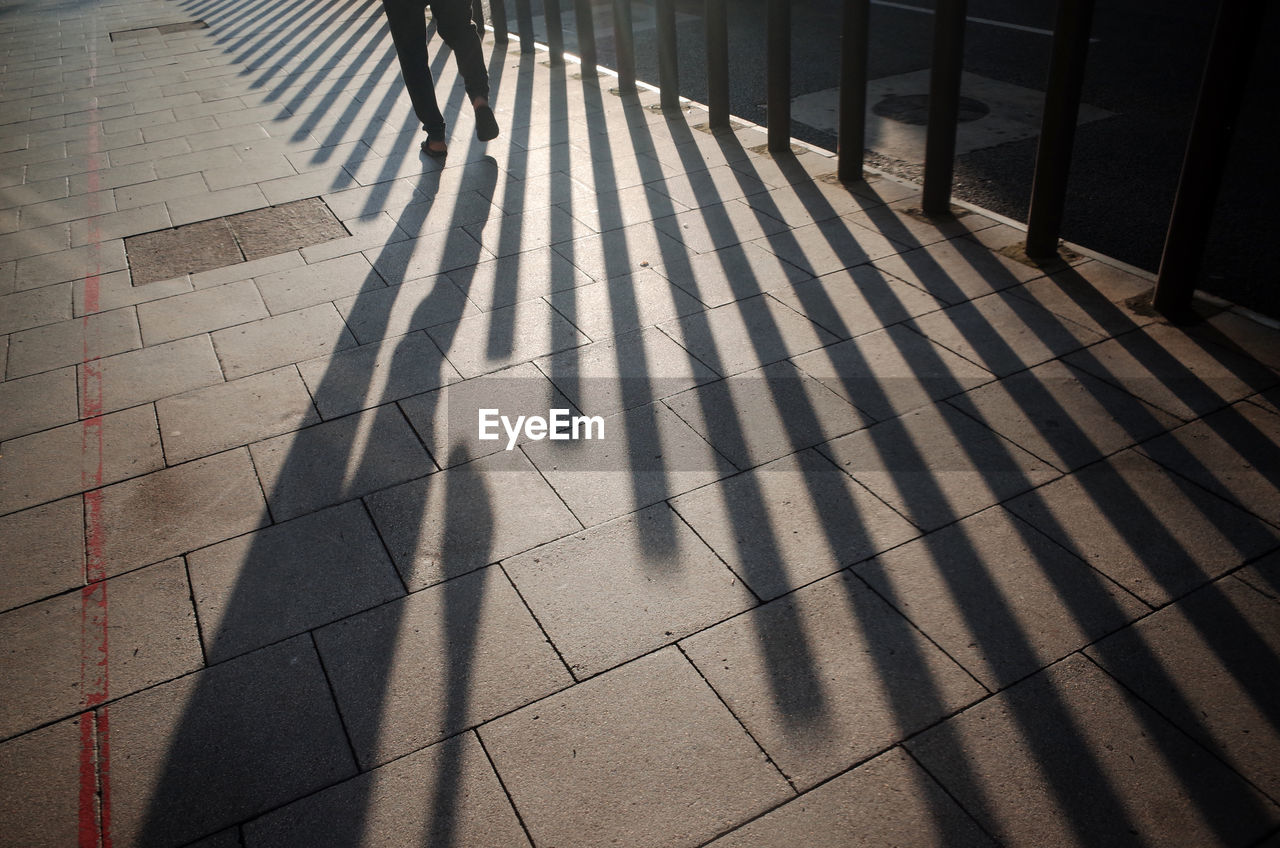 Shadow of person on footpath