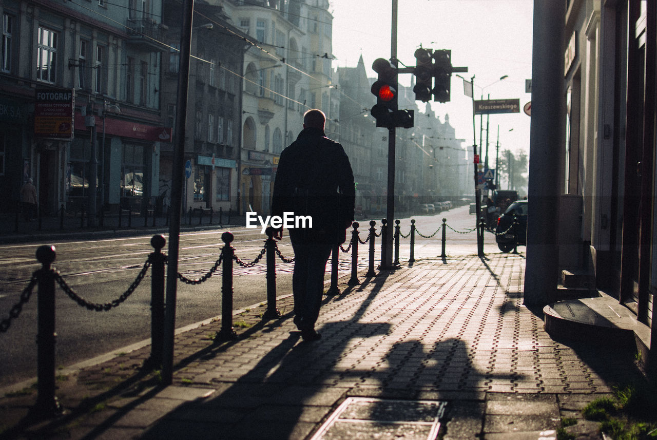 PEOPLE WALKING ON STREET IN CITY