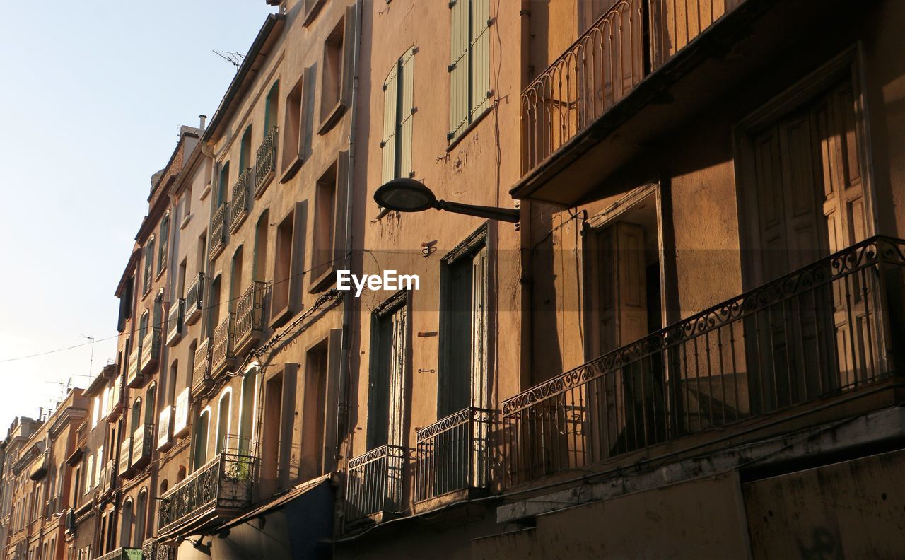 Low angle view of street light against building