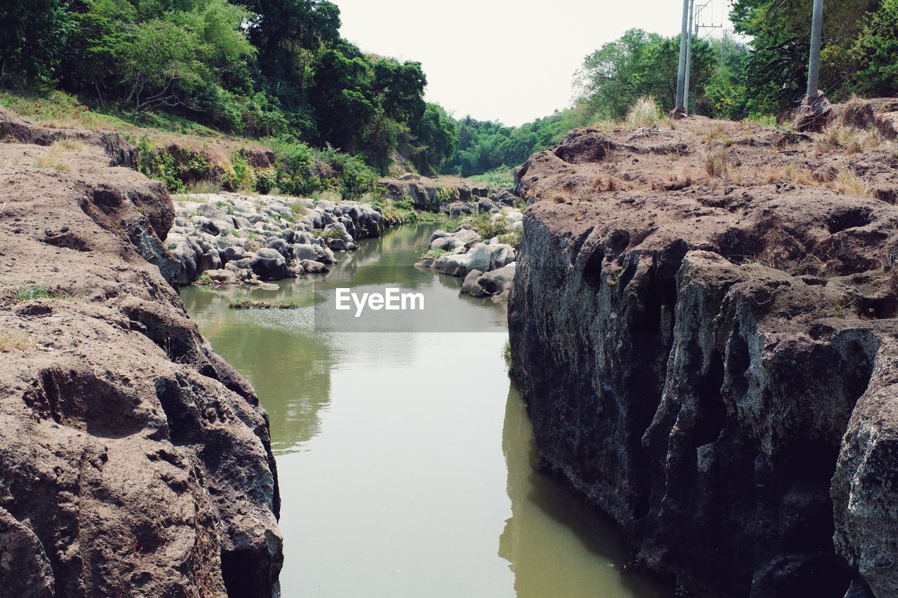 water, rock, river, nature, tree, plant, beauty in nature, scenics - nature, tranquility, day, no people, body of water, land, non-urban scene, wadi, tranquil scene, outdoors, rock formation, sky, environment, stream, landscape, forest, reflection, geology, waterway