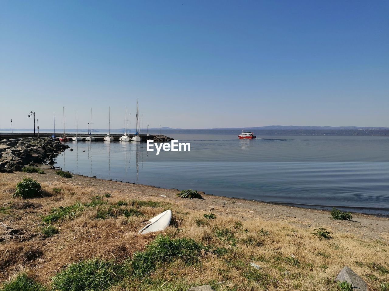 Scenic view of sea against clear blue sky