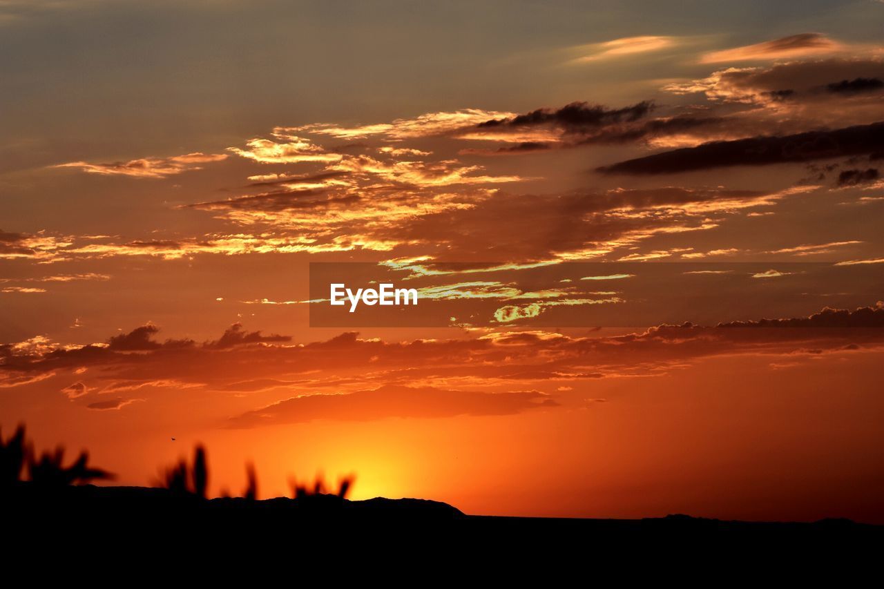 Scenic view of dramatic sky during sunset