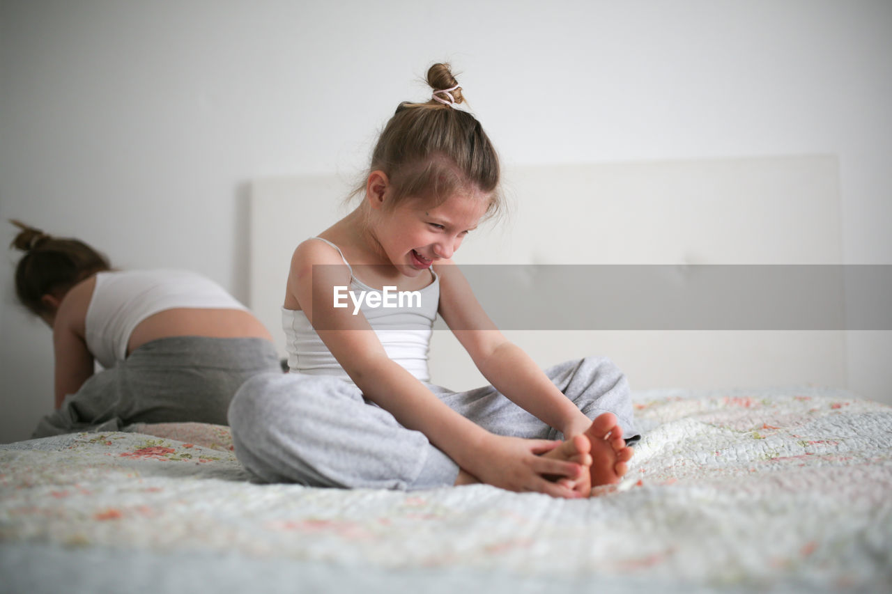 Funny offended and laughing kid girl, light background, real interior. concept childhood 