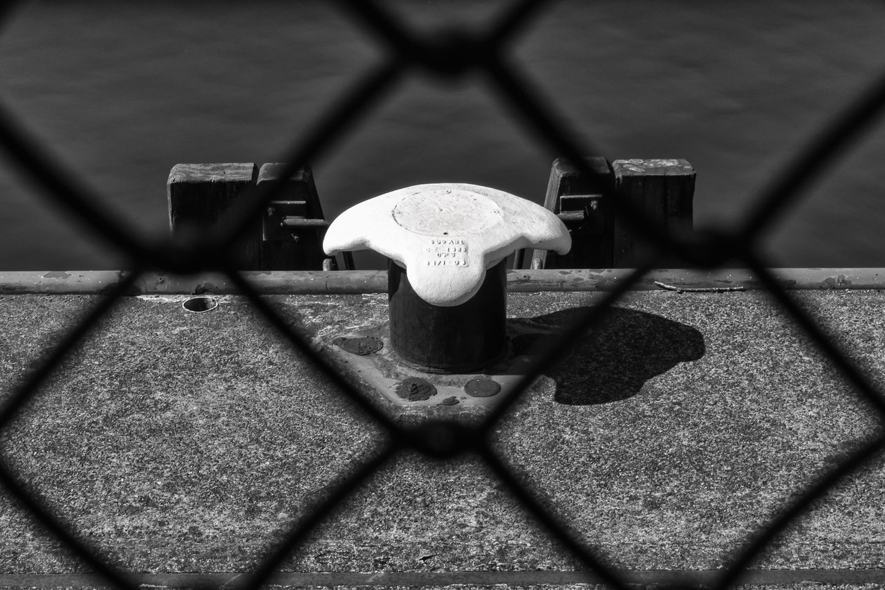 HIGH ANGLE VIEW OF CHAINLINK FENCE ON TABLE AT SIDEWALK