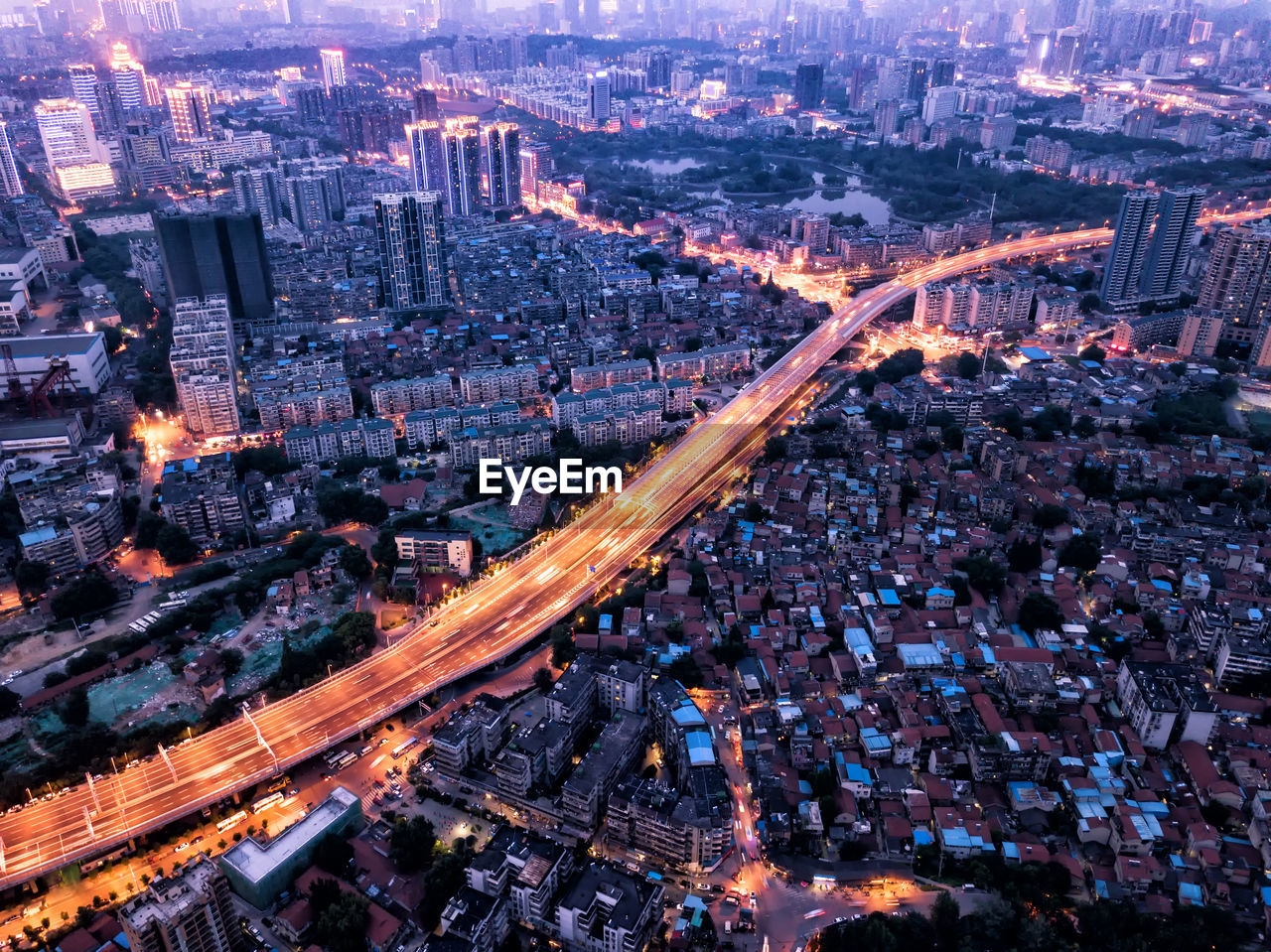 Aerial view of bridge amidst cityscape at dusk