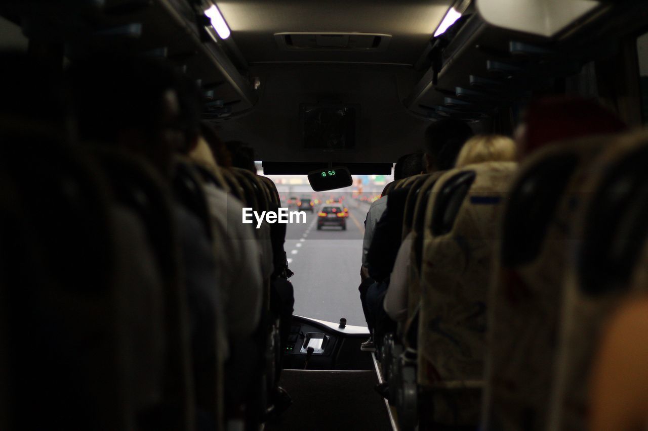 Rear view of people in bus on street