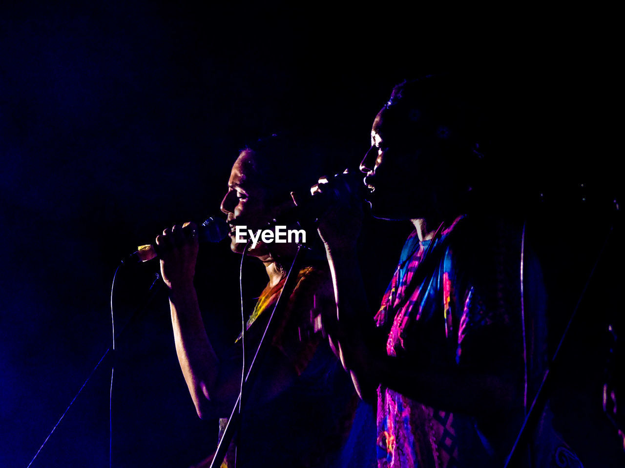 Two women singing on stage