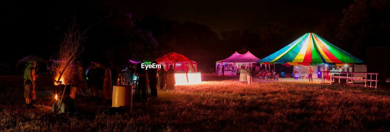 Tents on landscape at night