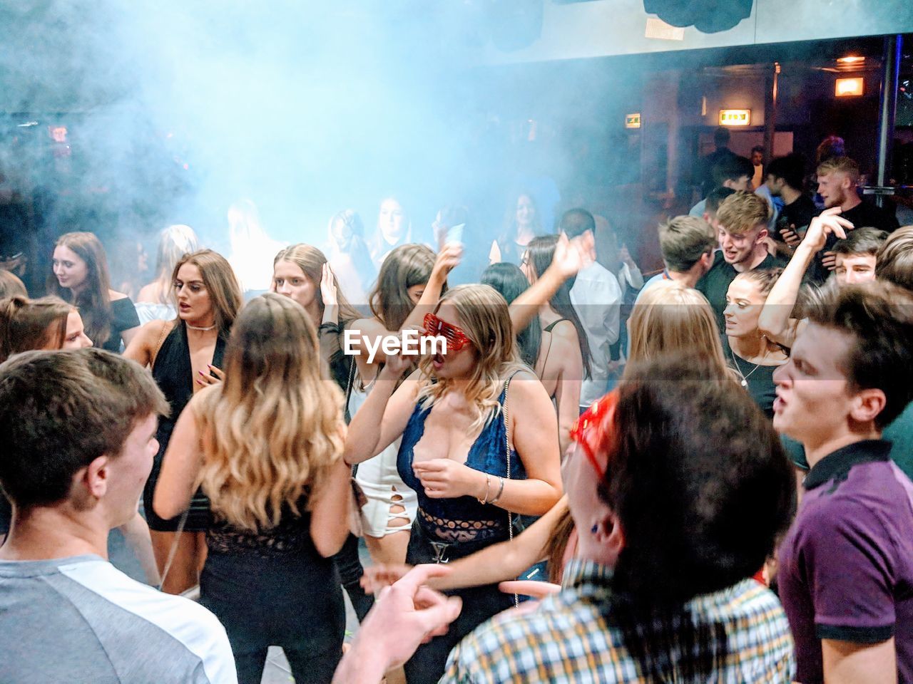 GROUP OF PEOPLE DANCING IN MUSIC FESTIVAL