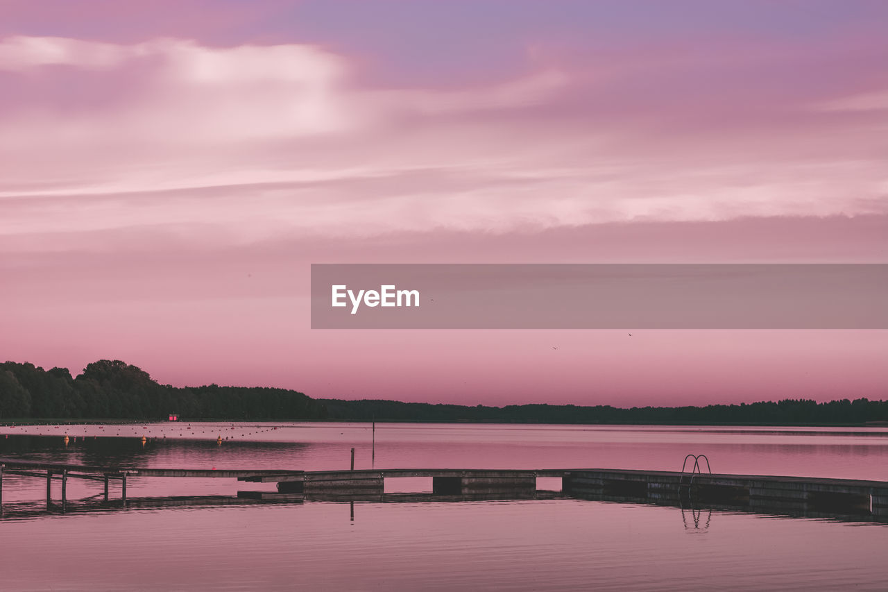 Scenic view of lake against sky during sunset