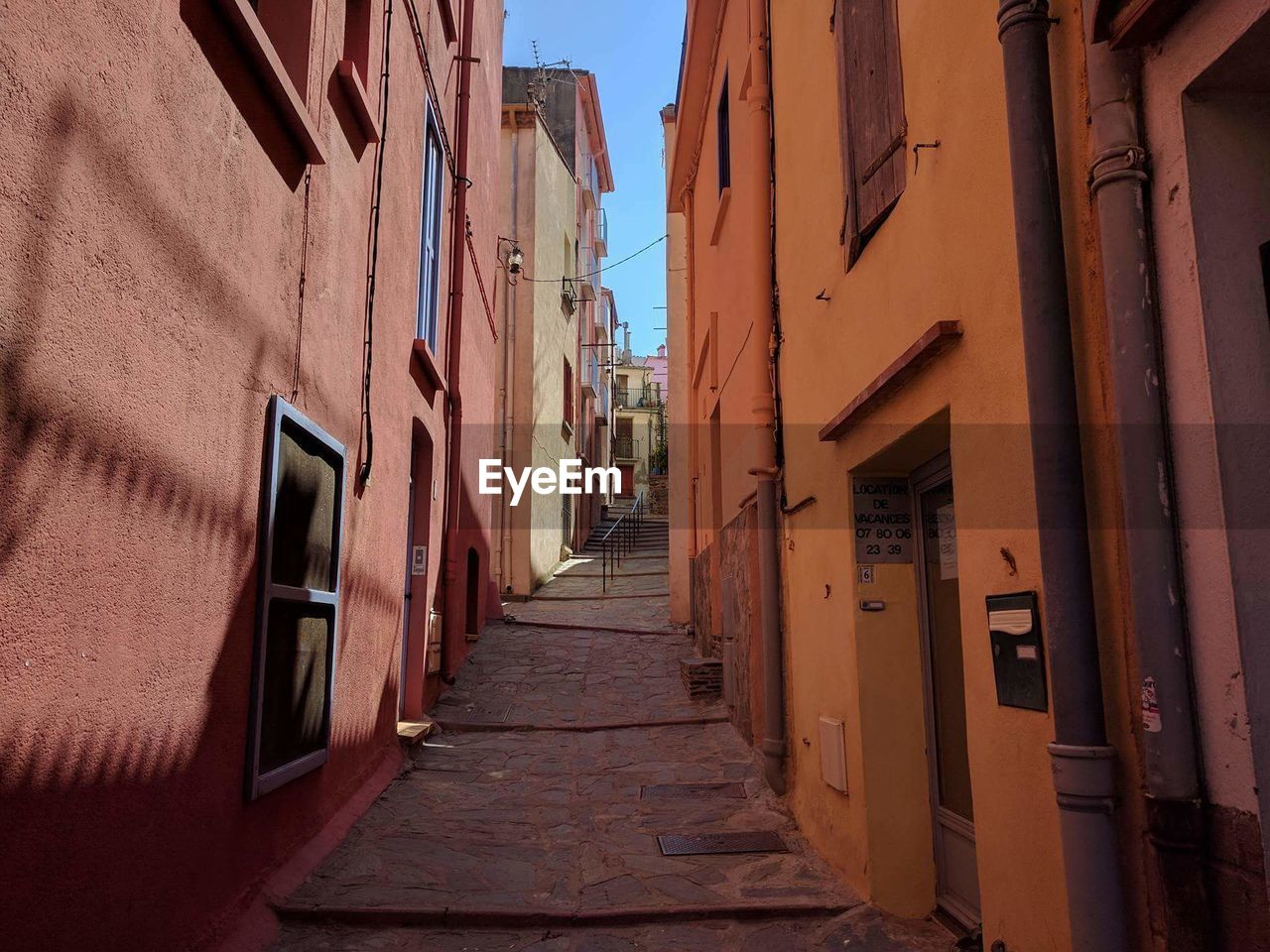 ALLEY AMIDST HOUSES AND RESIDENTIAL BUILDINGS