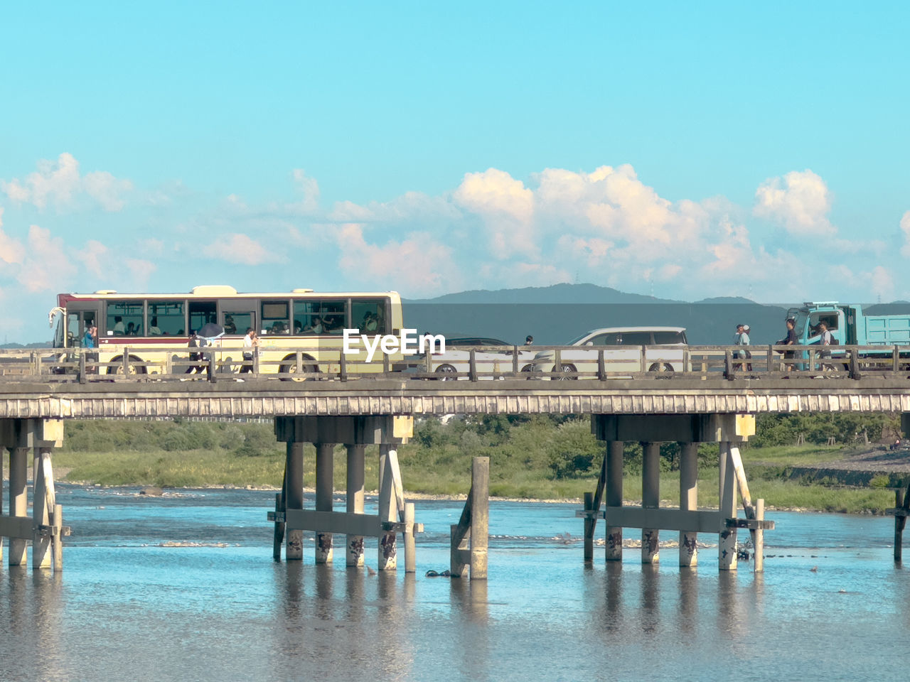 water, sky, pier, architecture, built structure, nature, sea, vacation, transportation, cloud, bridge, travel, reflection, day, travel destinations, beach, building exterior, outdoors, coast, blue, land, tourism, dock, no people, mode of transportation, shore, city, ocean