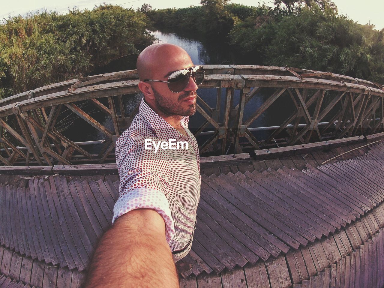 Fish eye view of man standing on footbridge