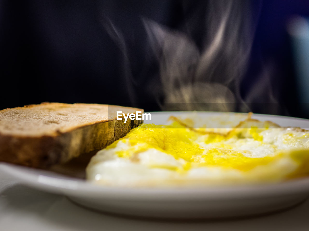 Close-up of omelet with bread in plate on table