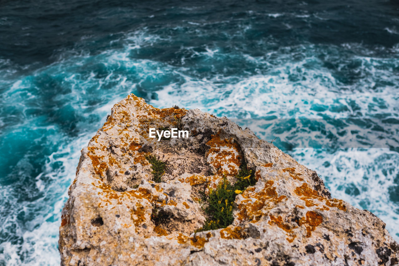 High angle view of rock formation in sea