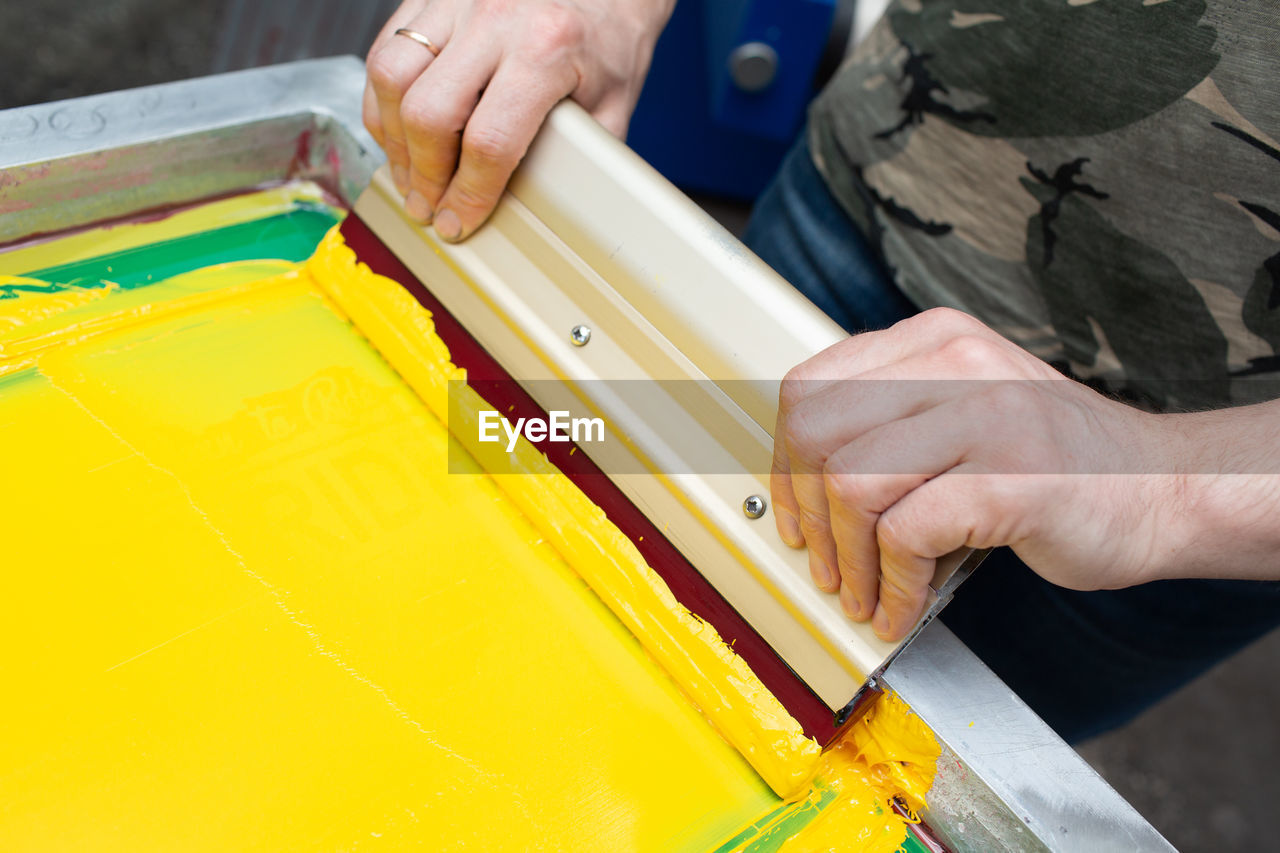 Midsection of person holding yellow