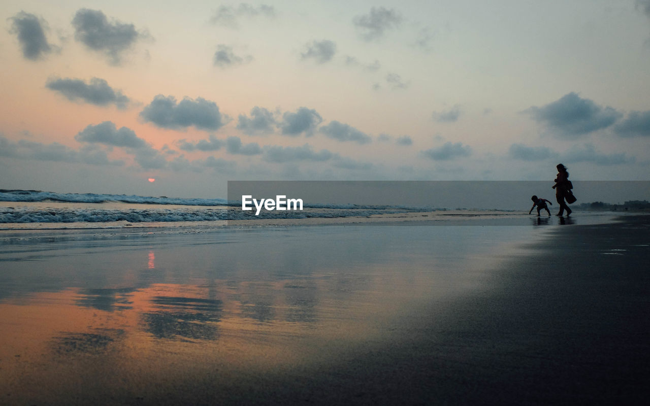 PEOPLE AT BEACH DURING SUNSET