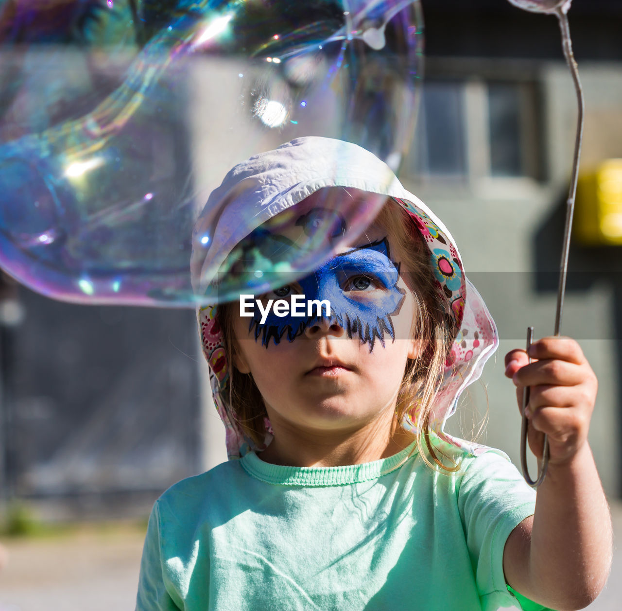 Close-up of girl looking at bubble