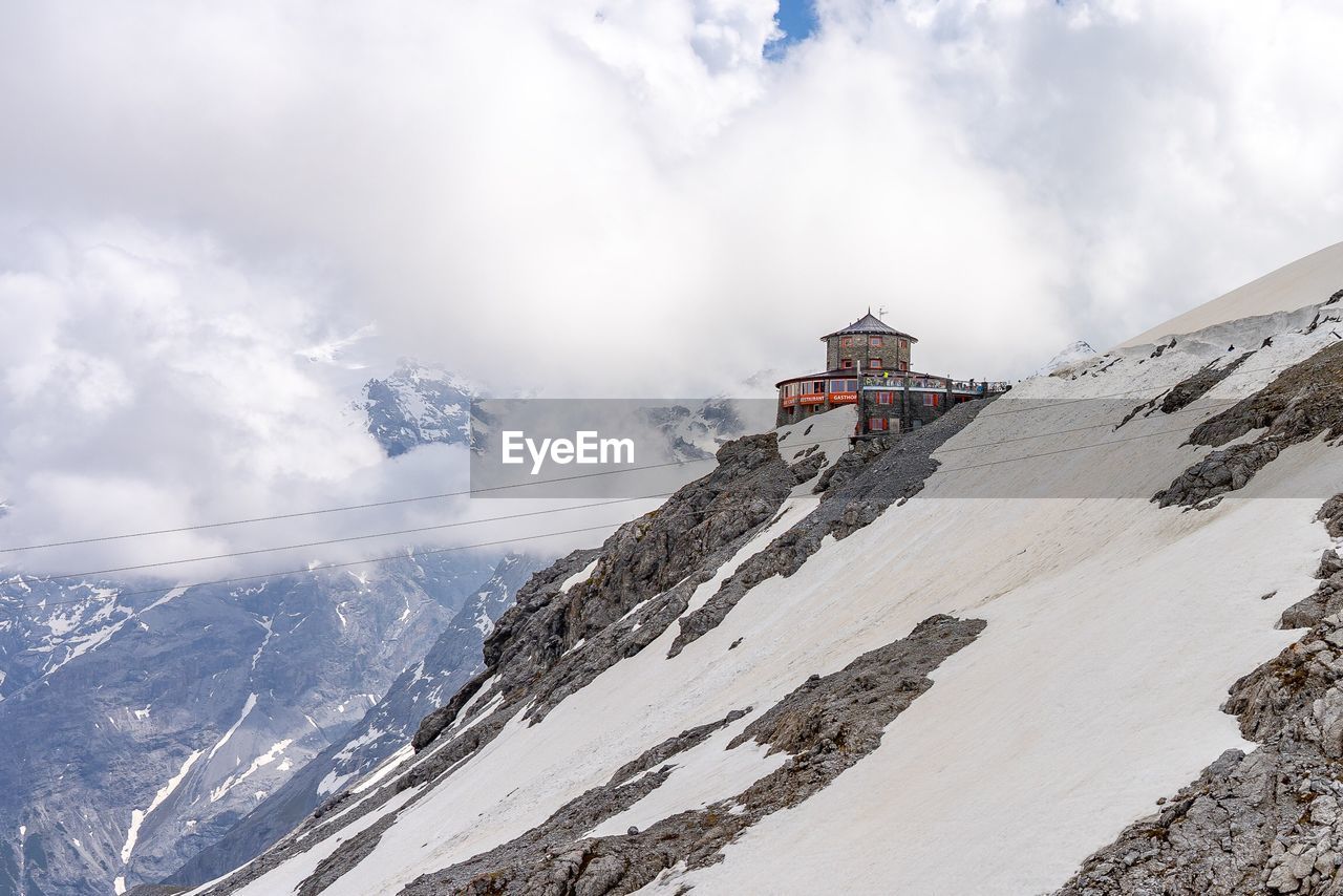 View of snowcapped mountain against cloudy sky