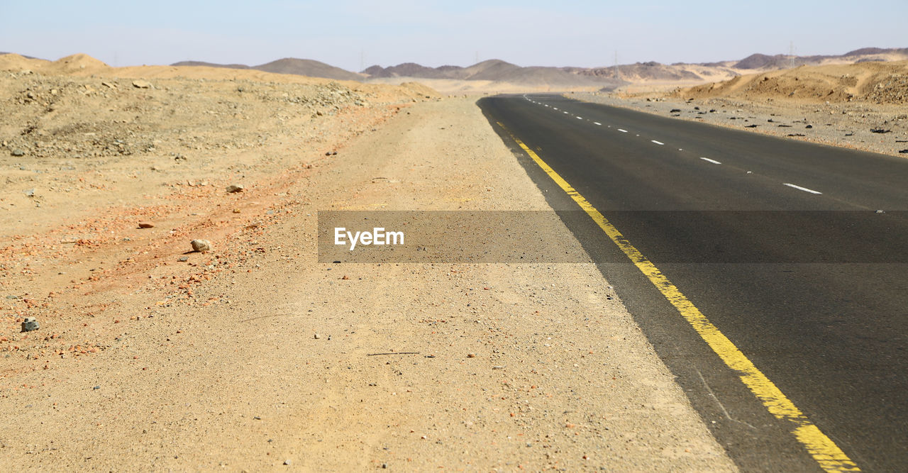 VIEW OF ROAD PASSING THROUGH A DESERT