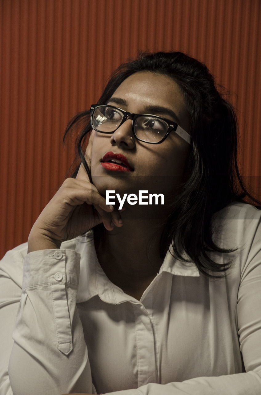 YOUNG WOMAN WITH EYEGLASSES