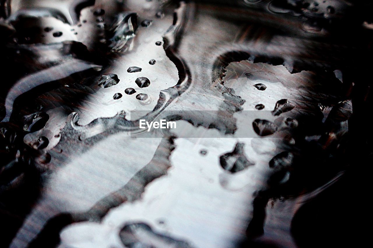 Close-up of spilled water on table