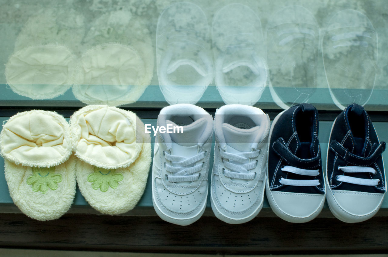 High angle view of baby shoes on window sill