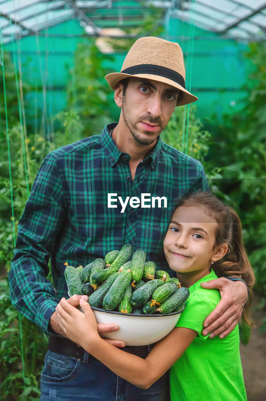 portrait of young man holding vegetables