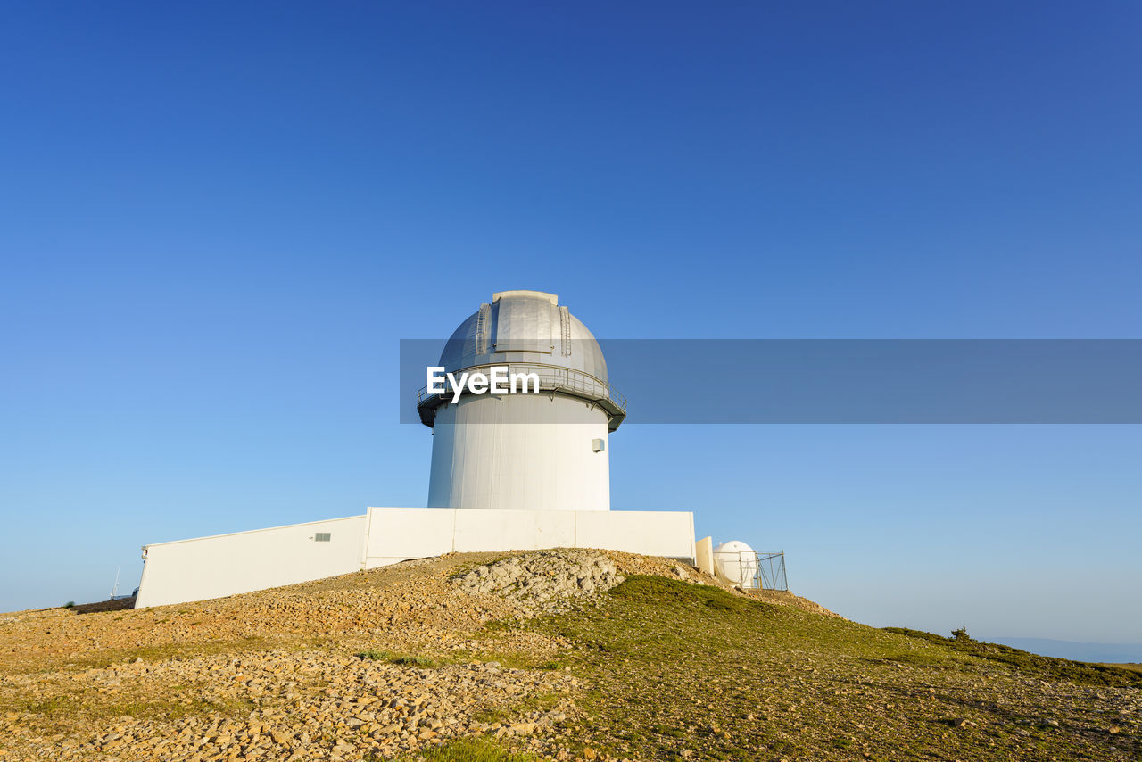 Telescope on top of a mountain in the astrophysical observatory of javalambre, teruel, spain