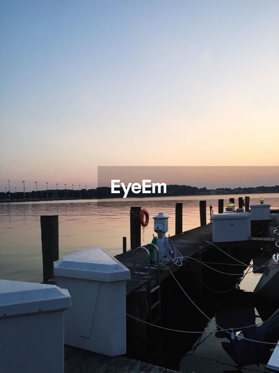 Pier over lake during sunset