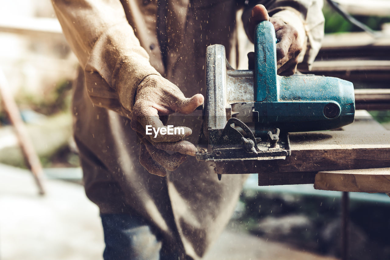 Close-up of man working with machine