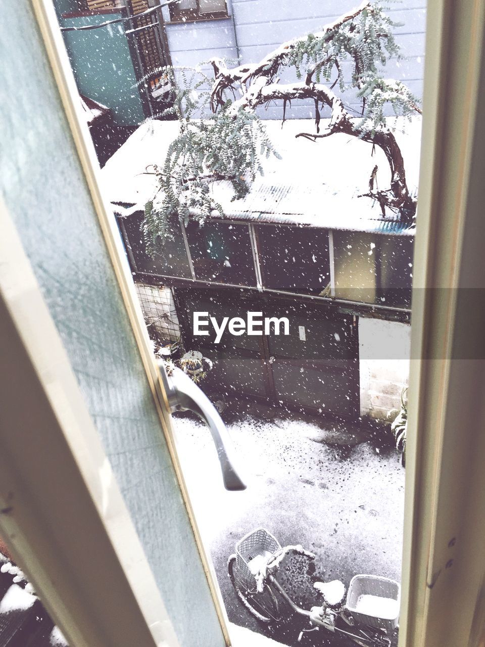 Elevated view of bicycle from window during snowfall