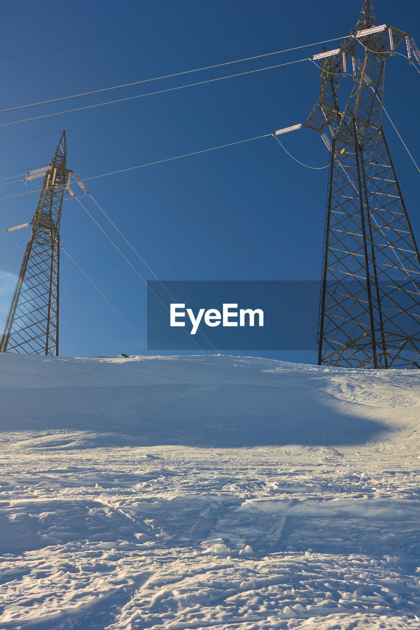 SNOW COVERED FIELD AGAINST SKY