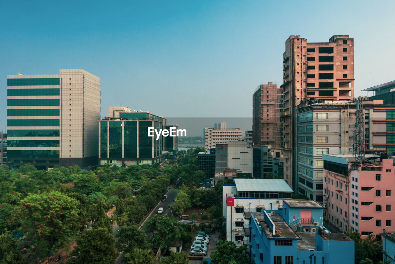 Buildings in city against clear sky