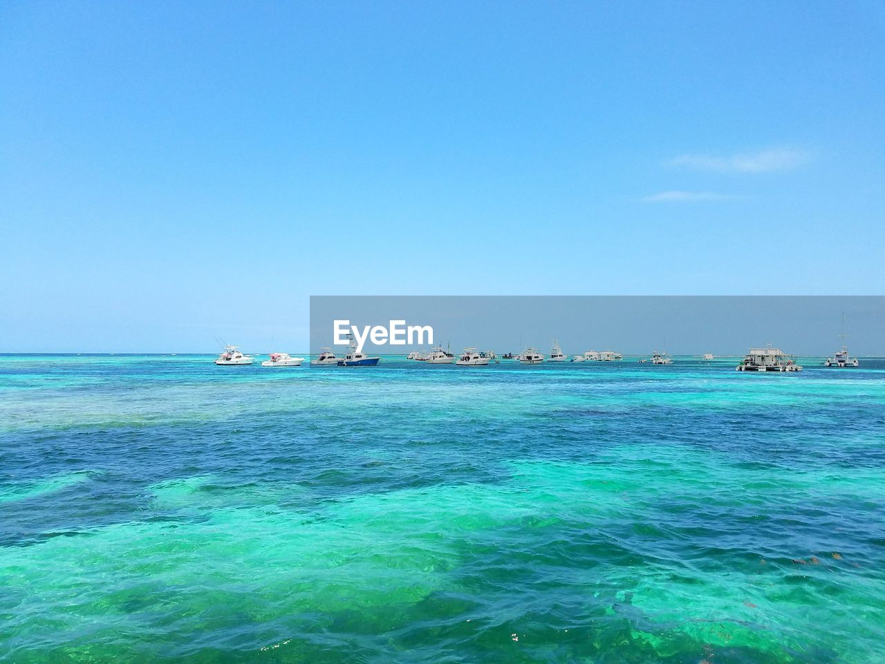 SAILBOATS IN SEA AGAINST CLEAR SKY