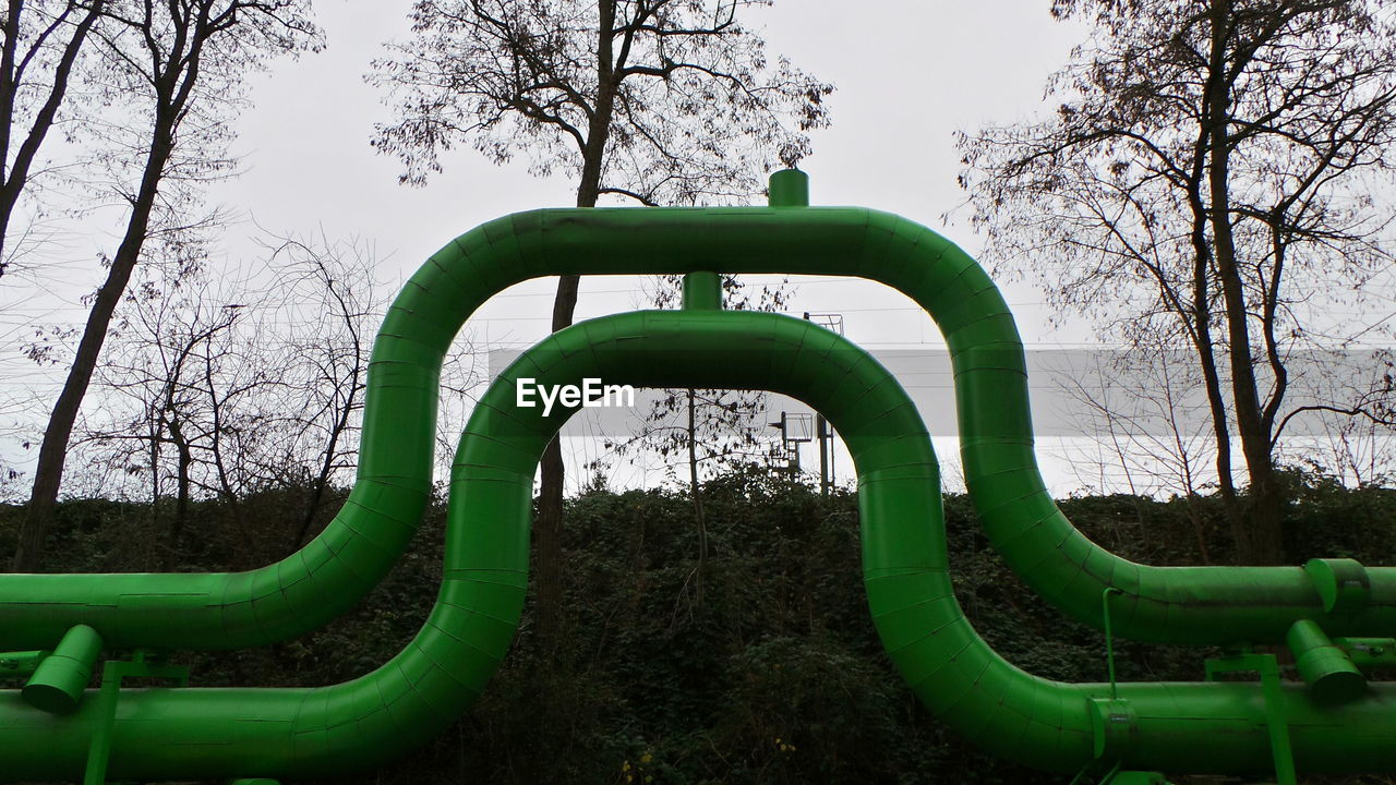 Low angle view of green pipeline at field