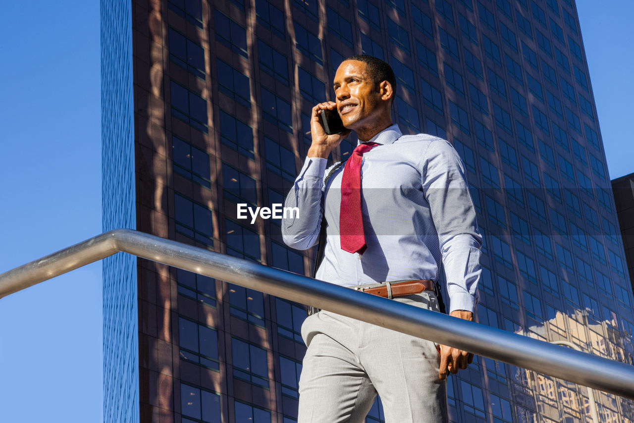 low angle view of young man standing in city