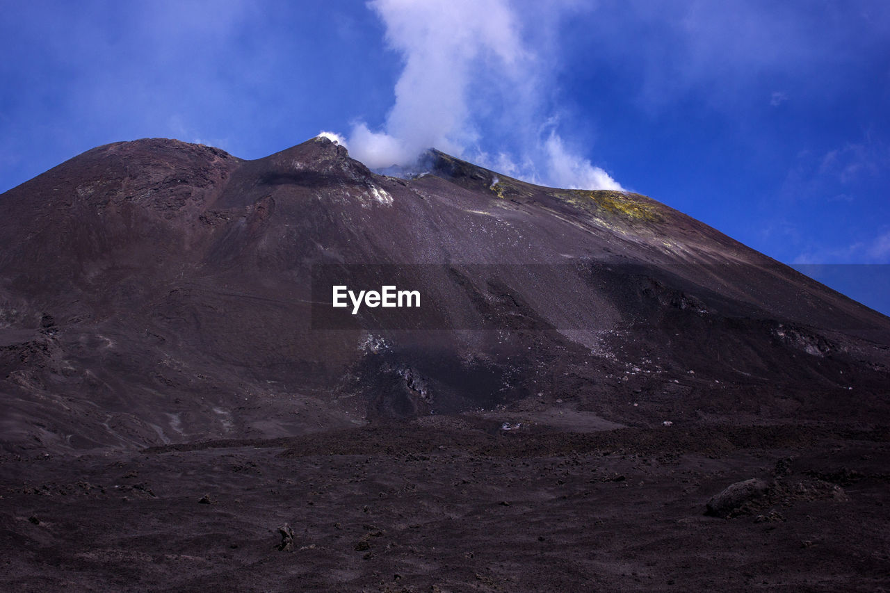 Scenic view of volcanic mountain against sky