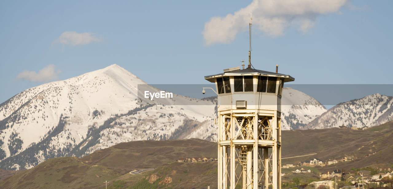 TOWER ON SNOWCAPPED MOUNTAINS AGAINST SKY