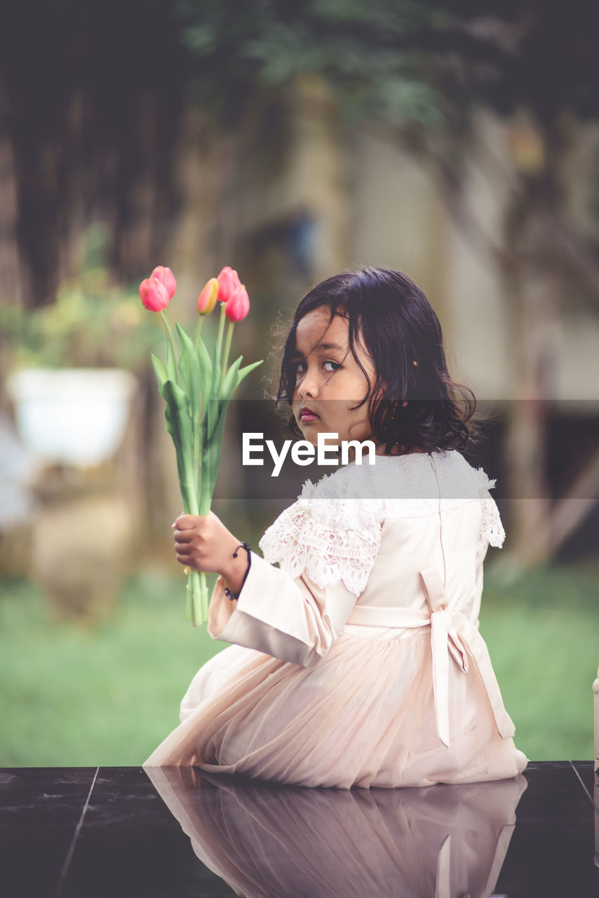 Woman looking at flower bouquet