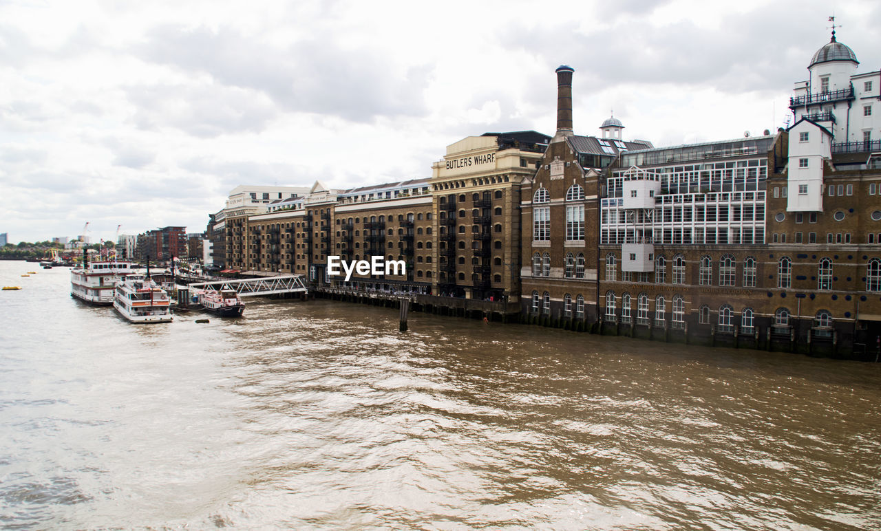 View of boats in river with buildings in background