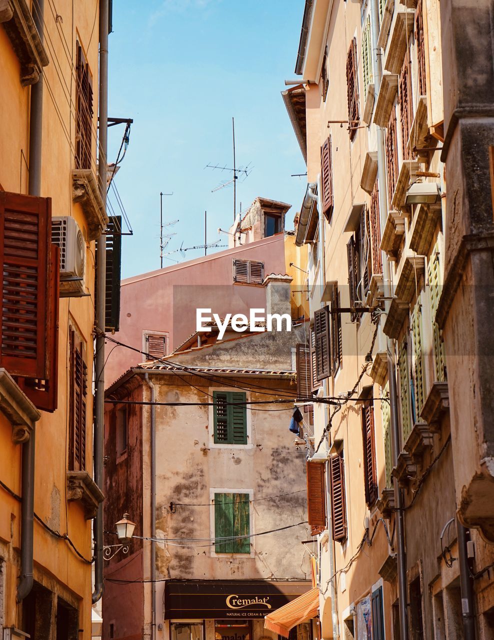 architecture, building exterior, built structure, town, road, neighbourhood, building, city, street, residential district, urban area, alley, sky, house, window, no people, nature, old, facade, cityscape, infrastructure, travel destinations, day, apartment, outdoors, balcony, low angle view, sunlight, downtown, travel, tourism