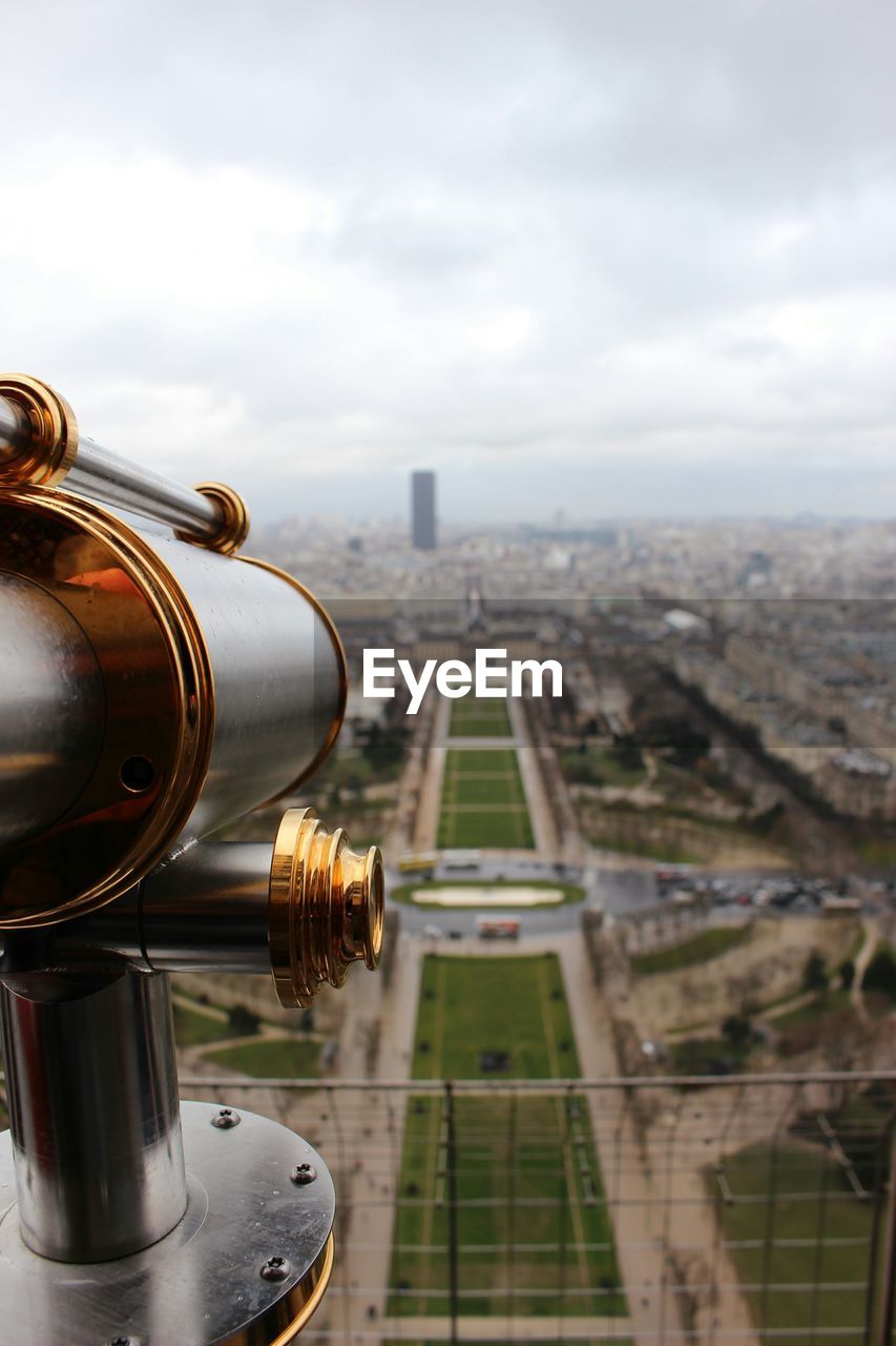 Coin-operated binoculars on eiffel tower overlooking city