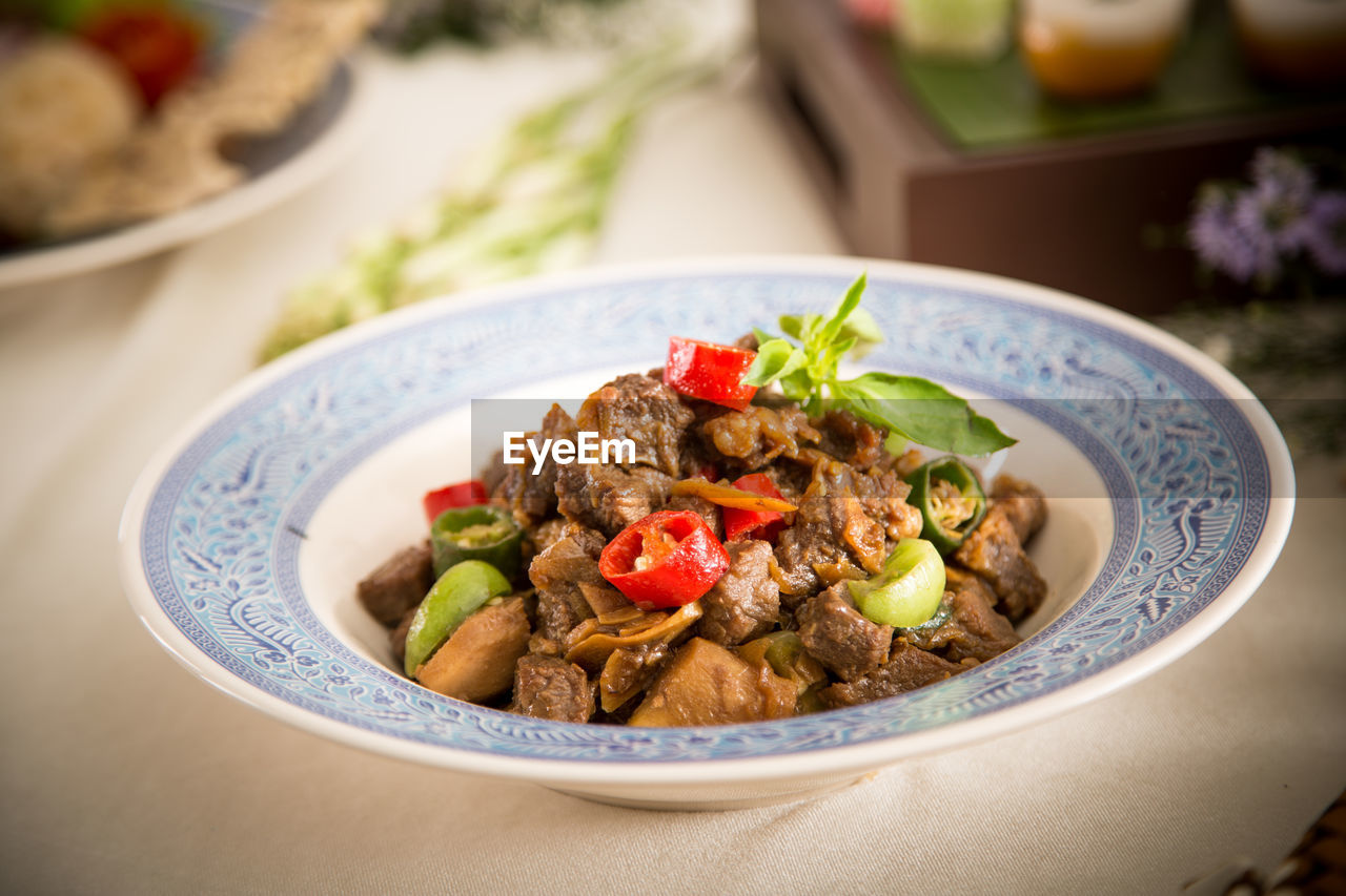 Close-up of meat in plate at table