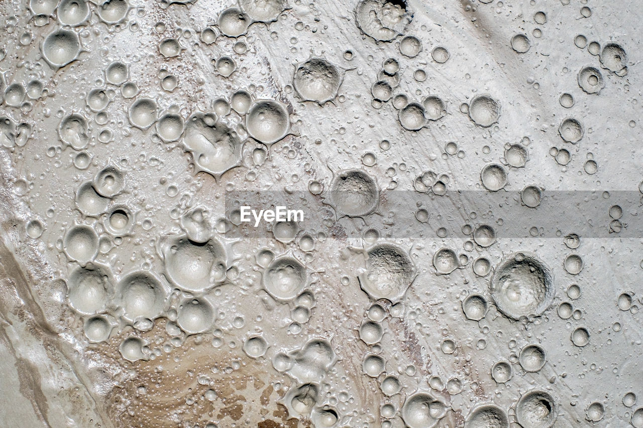 Small craters in mud volcanoes's clay river