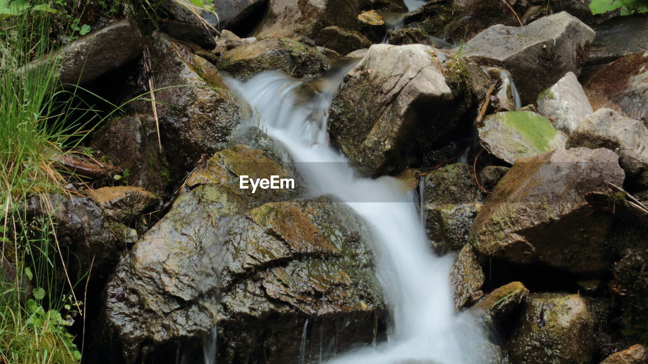 STREAM FLOWING THROUGH ROCKS