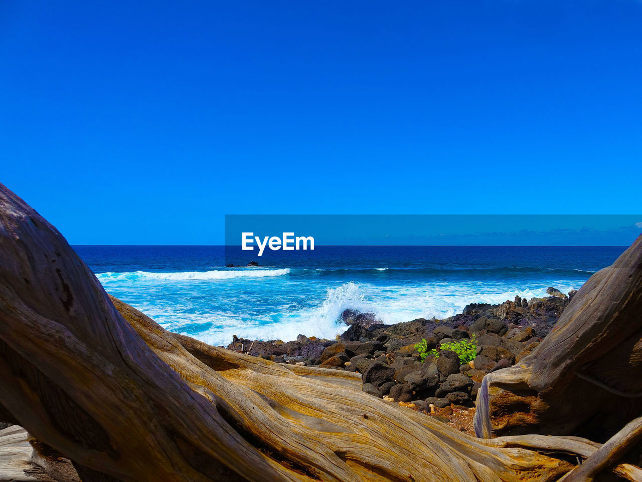 Scenic view of sea against clear blue sky