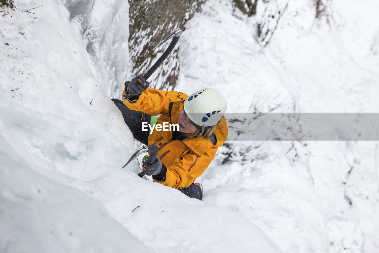 High angle view of woman ice climbing at white mountains during winter